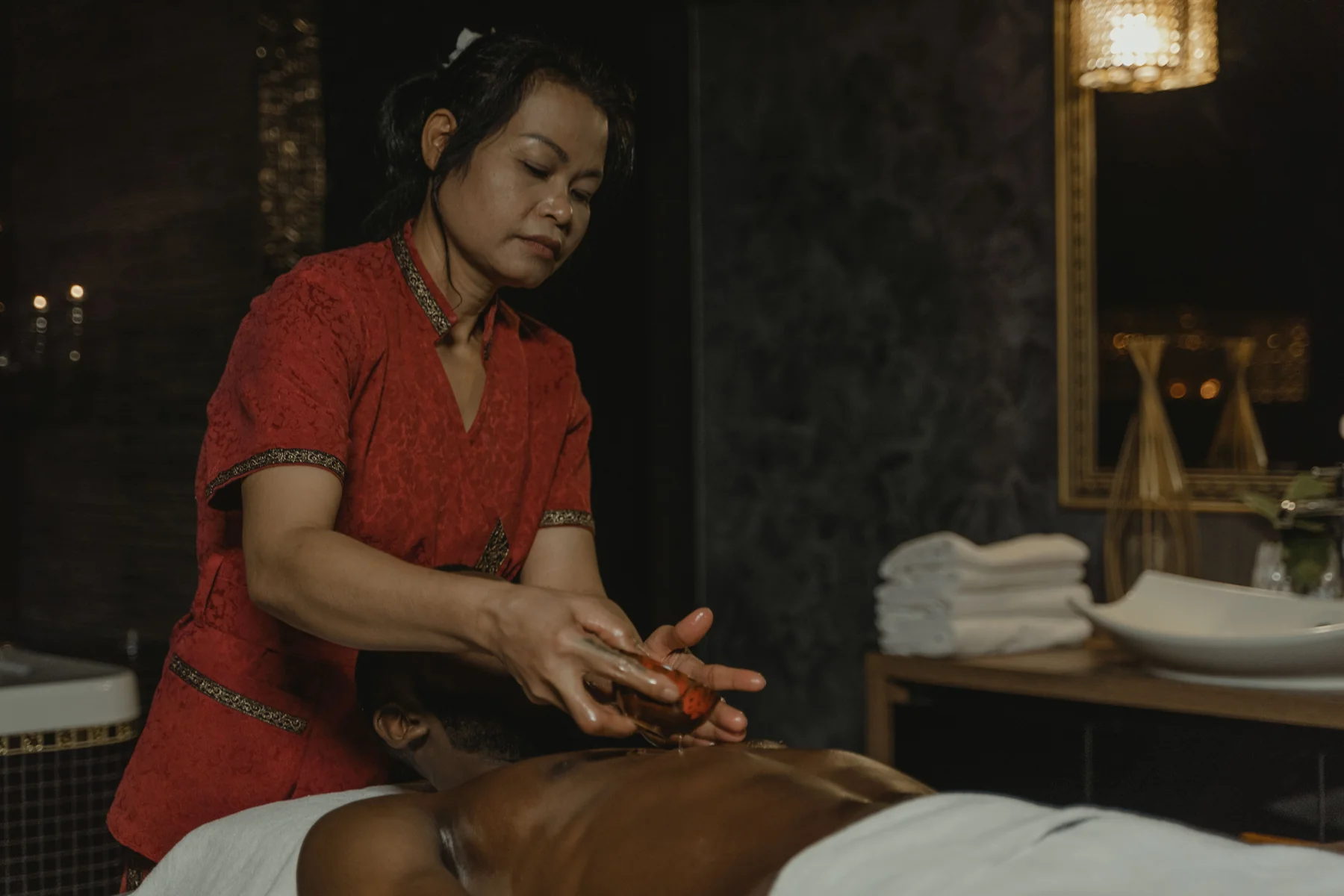 Asian massage professional preparing a relaxing spa session